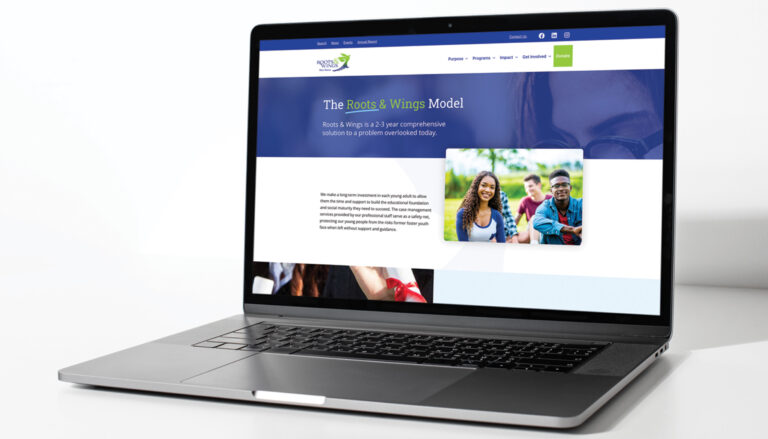 Roots and Wings website displayed on a laptop