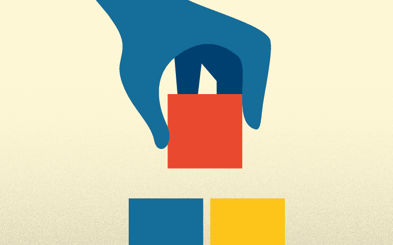 Illustration of hand holding a block above two other blocks to stack