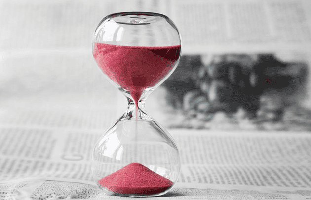 Photo of running hourglass with red sand