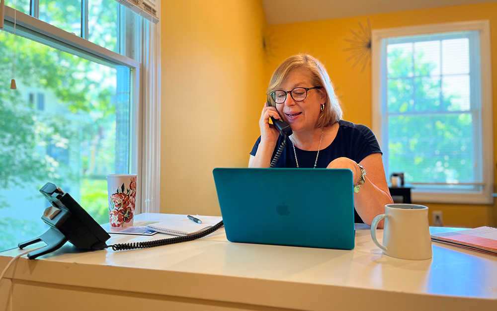 FatRabbit CFO Cheryl McNamara smiling on the phone with a marketing client