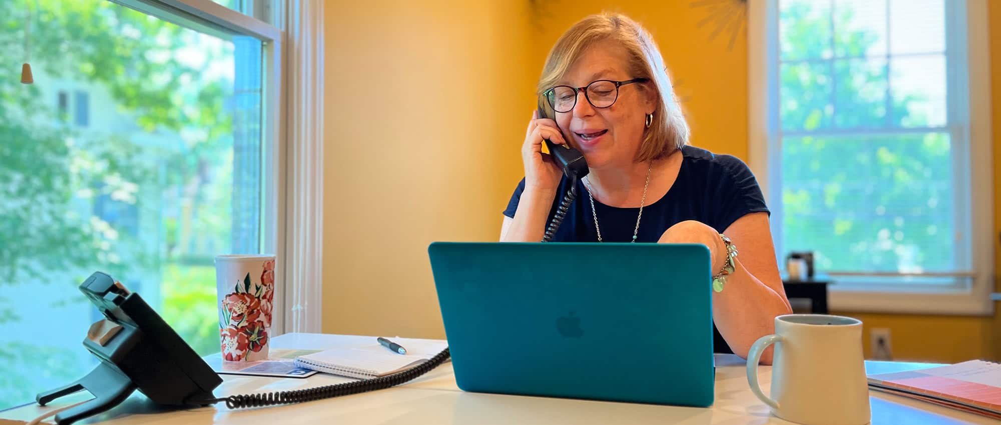 FatRabbit CFO Cheryl McNamara smiling on the phone