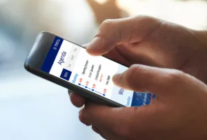 hands holding phone with summit online agenda on screen
