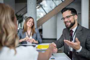Businessman is shaking hands with a client during a business meeting at the office, concluding a successful deal and establishing a new partnership