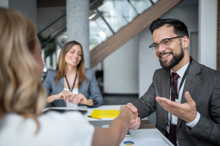 Businessman is shaking hands with a client during a business meeting at the office, concluding a successful deal and establishing a new partnership